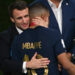 France's President Emmanuel Macron hugs France's Kylian Mbappe. PictureAlliance / Icon Sport