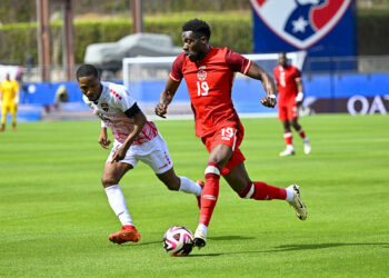 Mar 23, 2024; Frisco, Texas, USA; Canada midfielder Alphonso Davies (19) moves the ball past Trinidad and Tobago defender Shannon Gomez (14) during the first half at Toyota Stadium. Mandatory Credit: Jerome Miron-USA TODAY Sports/Sipa USA   - Photo by Icon Sport
